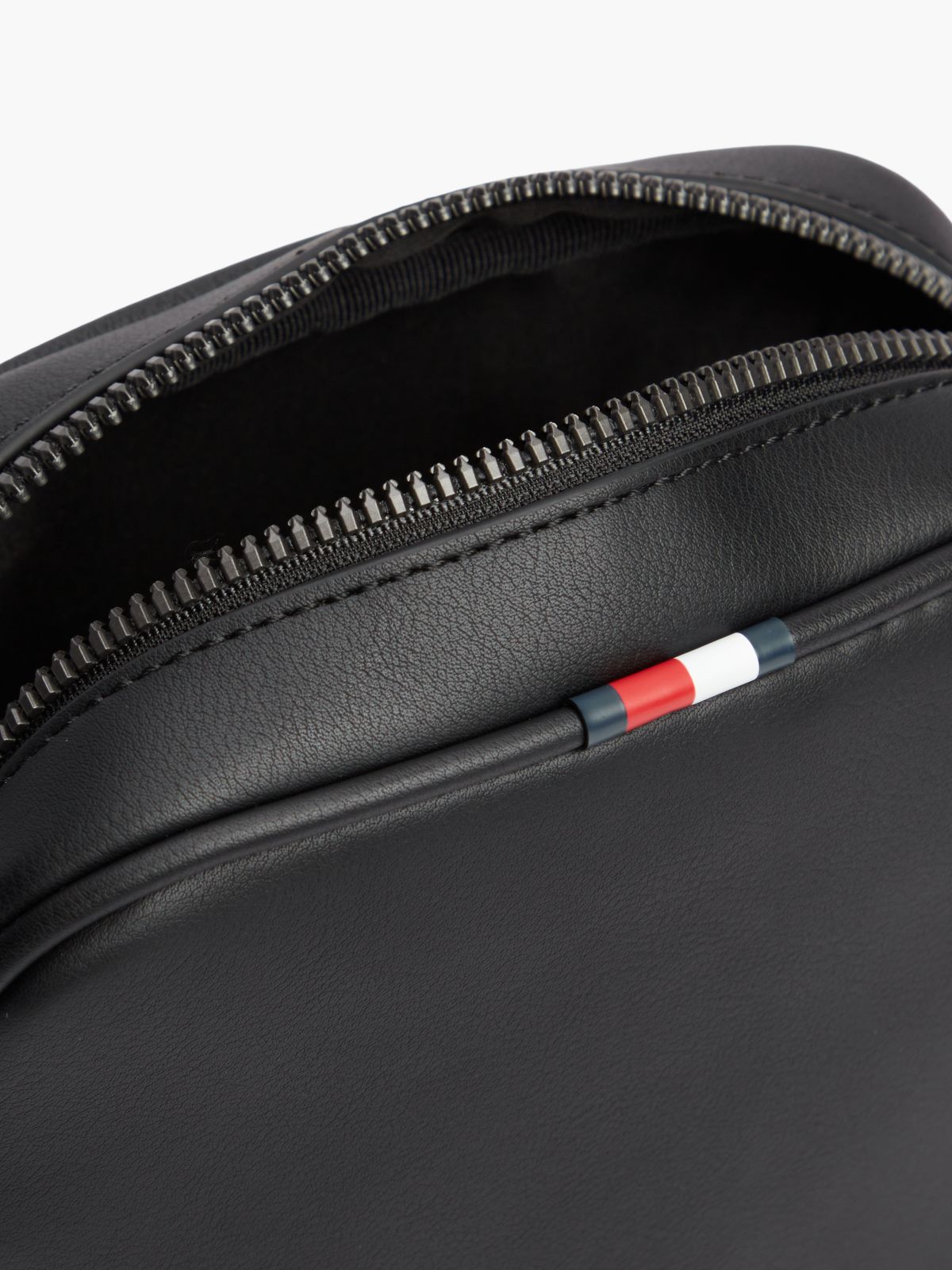 Enamel Flag Perforated Crossbody Reporter Bag — Black