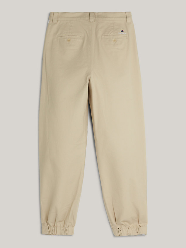 beige dual gender tapered logo tape chinos for men tommy jeans