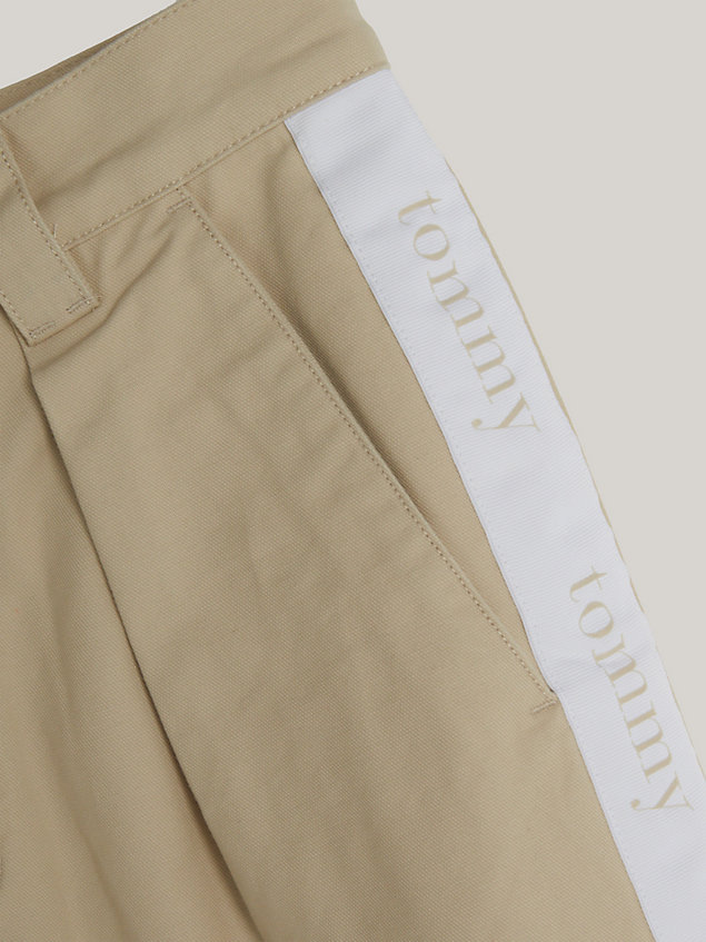 beige dual gender tapered logo tape chinos for men tommy jeans