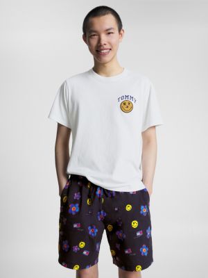 white tommy jeans x smiley® dual gender flag t-shirt for men tommy jeans