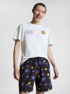 white tommy jeans x smiley® classic fit graphic t-shirt for men tommy jeans