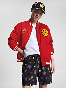 red tommy jeans x smiley® badge varsity jacket for men tommy jeans