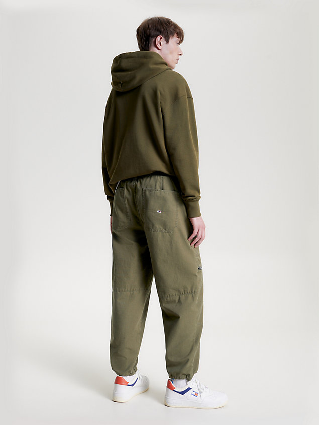 green aiden baggy fit tapered trousers for men tommy jeans