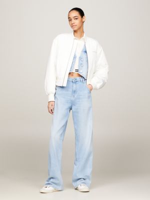 Woman in White Tommy Hilfiger Sports Bra and Distressed Blue Denim