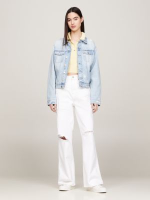 Woman in White Tommy Hilfiger Sports Bra and Distressed Blue Denim