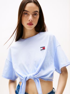 blauw cropped t-shirt met knoop en tommy-badge voor dames - tommy jeans