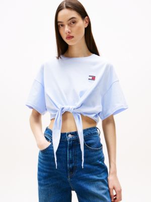 blauw cropped t-shirt met knoop en tommy-badge voor dames - tommy jeans