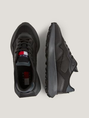 Trainers in leather and carbon clearance fibre