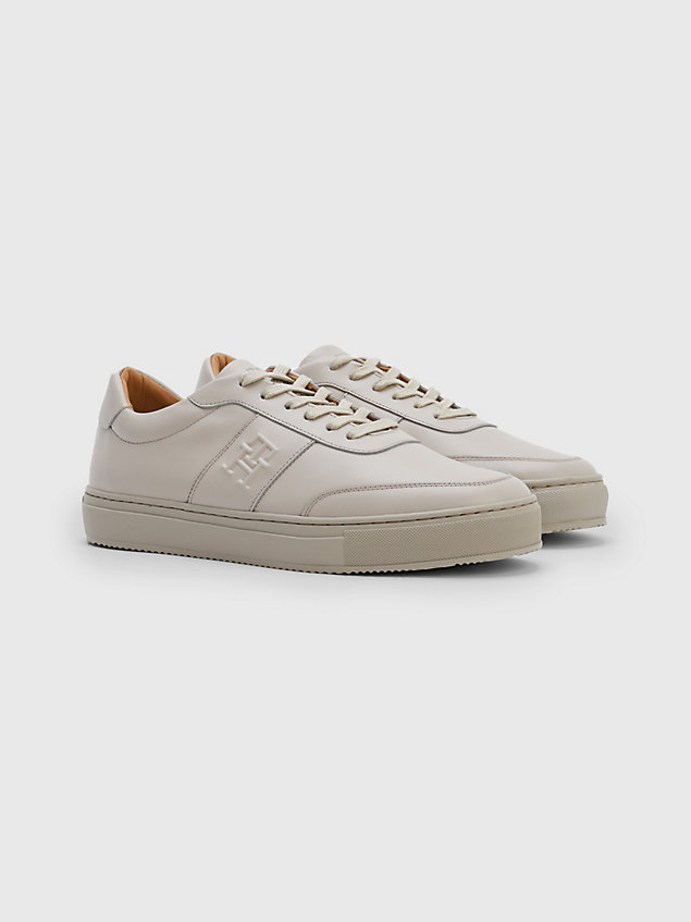 beige embossed monogram leather trainers for men tommy hilfiger