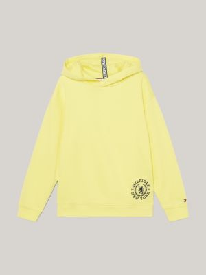 Sudadera amarilla con capucha y bandera pequeña en el pecho de Tommy Jeans