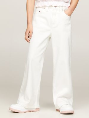 White jeans with store embroidery on legs