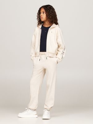 beige varsity curved logo relaxed joggers for girls tommy hilfiger