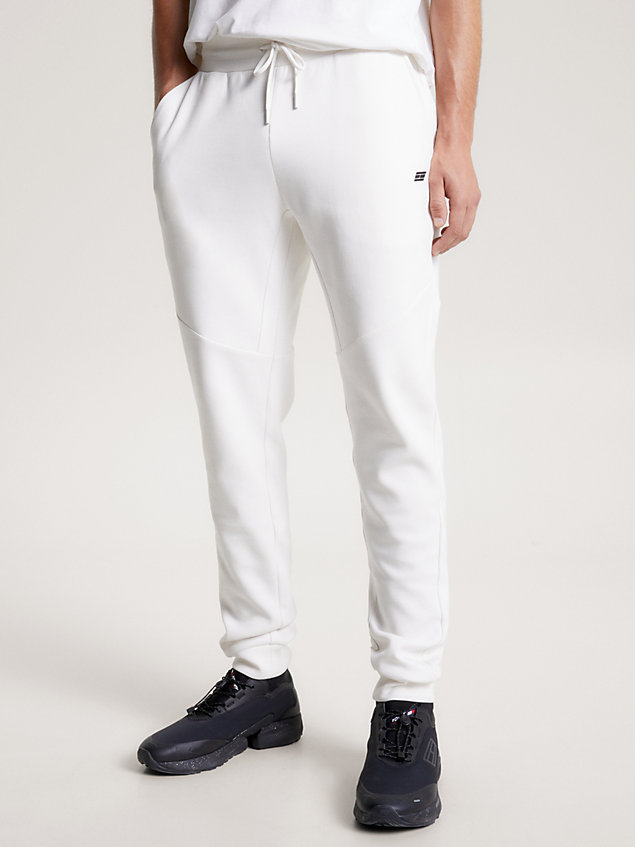 white sport essential tonal logo cuffed joggers for men tommy hilfiger