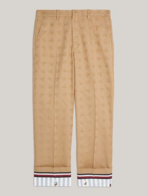 beige disney x tommy monogram regular chinos for men tommy hilfiger