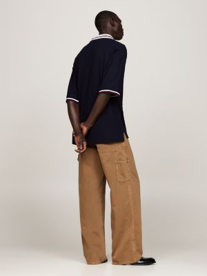polo de corte amplio con escudo bordado azul de hombres tommy hilfiger