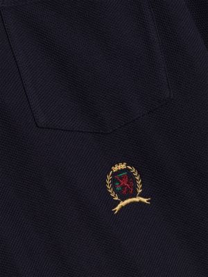 polo de corte amplio con escudo bordado azul de hombres tommy hilfiger