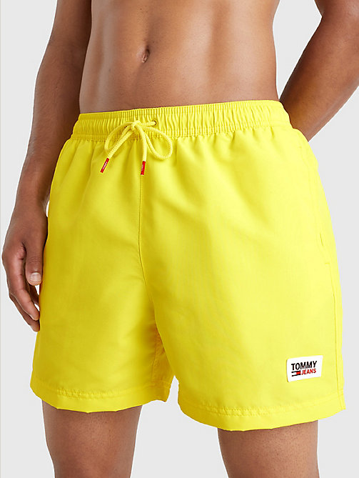 yellow logo patch mid length swim shorts for men tommy jeans