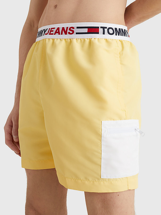 yellow logo waistband mid length swim shorts for men tommy jeans