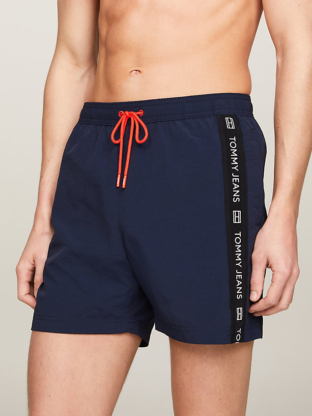 blue logo tape mid length slim swim trunks for men tommy jeans