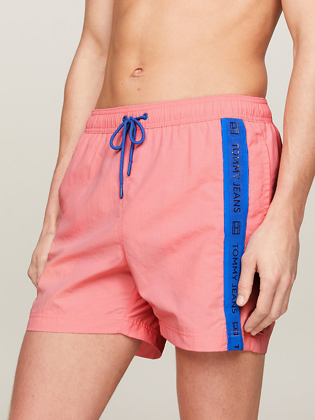 pink logo tape mid length slim swim trunks for men tommy jeans