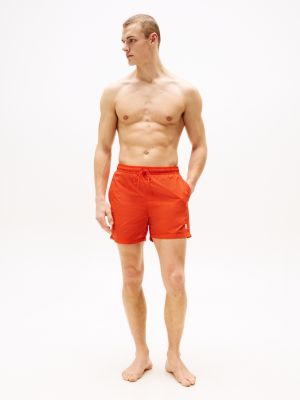 orange th monogram mid length swim trunks for men tommy hilfiger