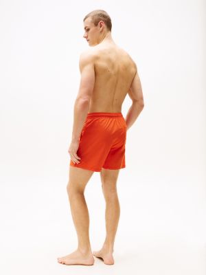 orange th monogram mid length swim trunks for men tommy hilfiger